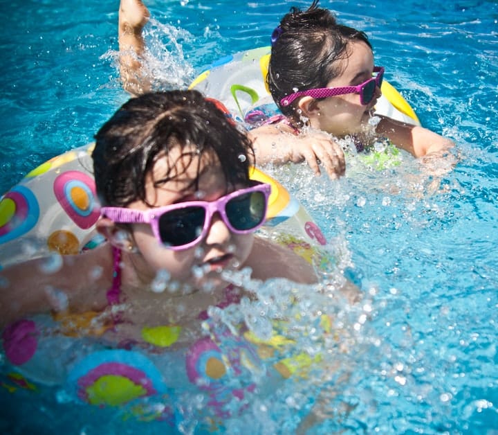 children swimming in pool