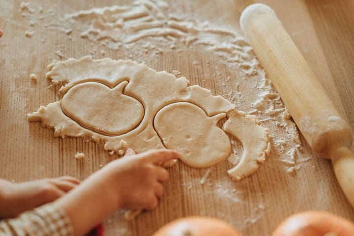 child cutting out dough