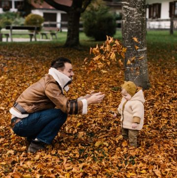 child and dad in leaves