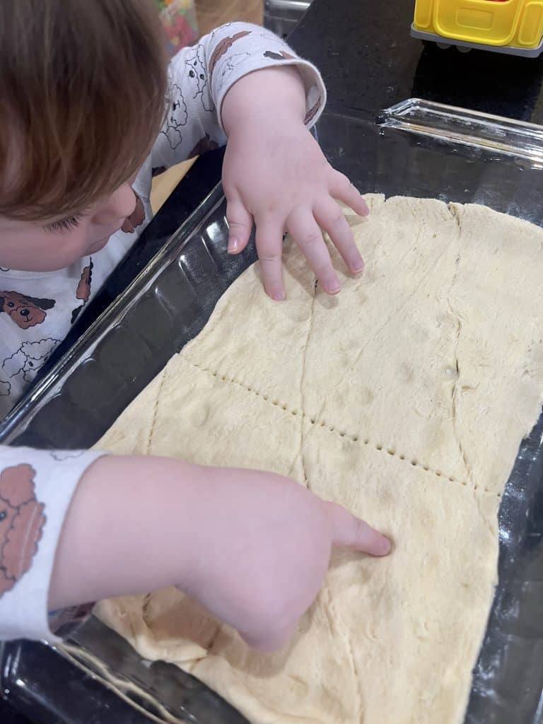 dough with toddler finger in it