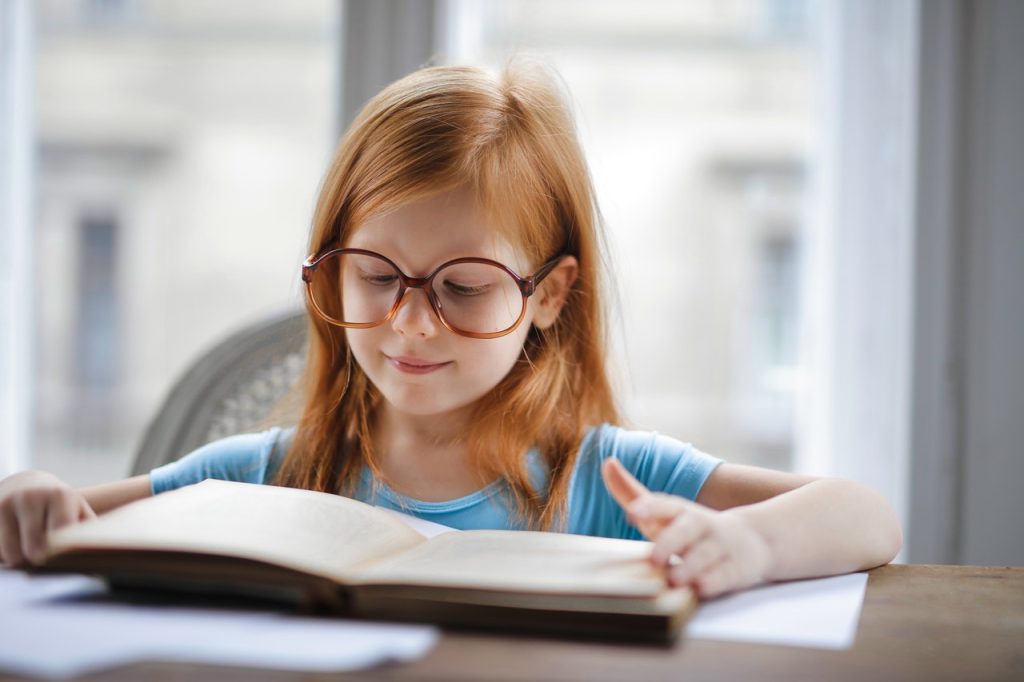 girl reading with glasses