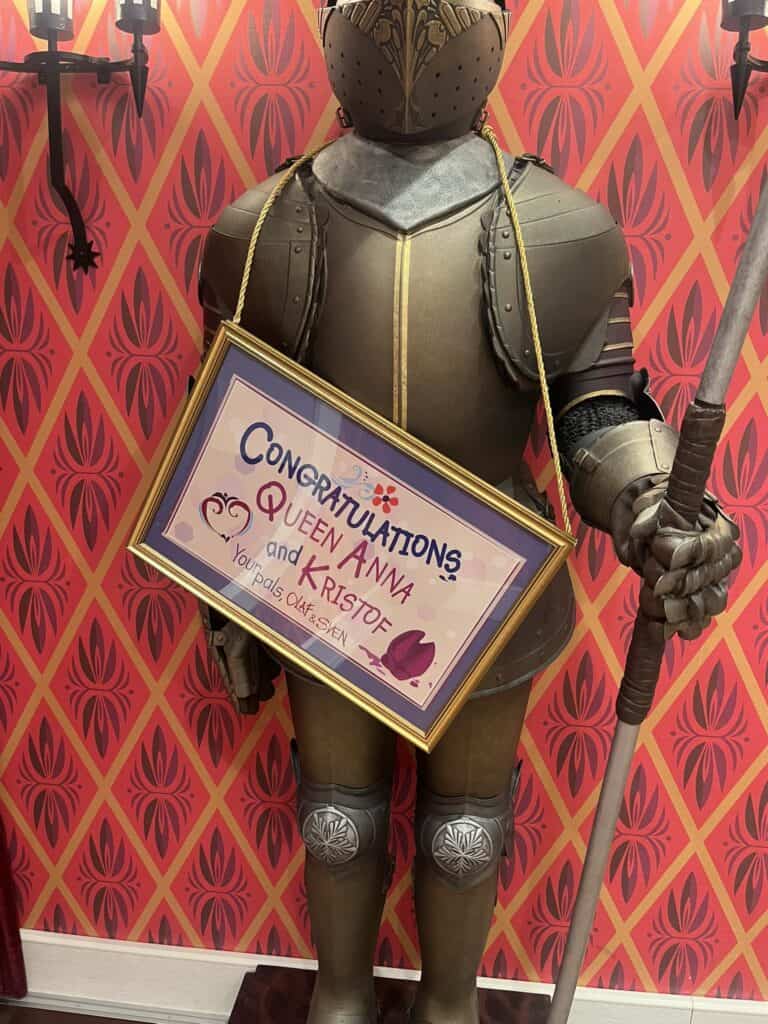 knight holding sign for queen Anna and Kristof at Arendelle